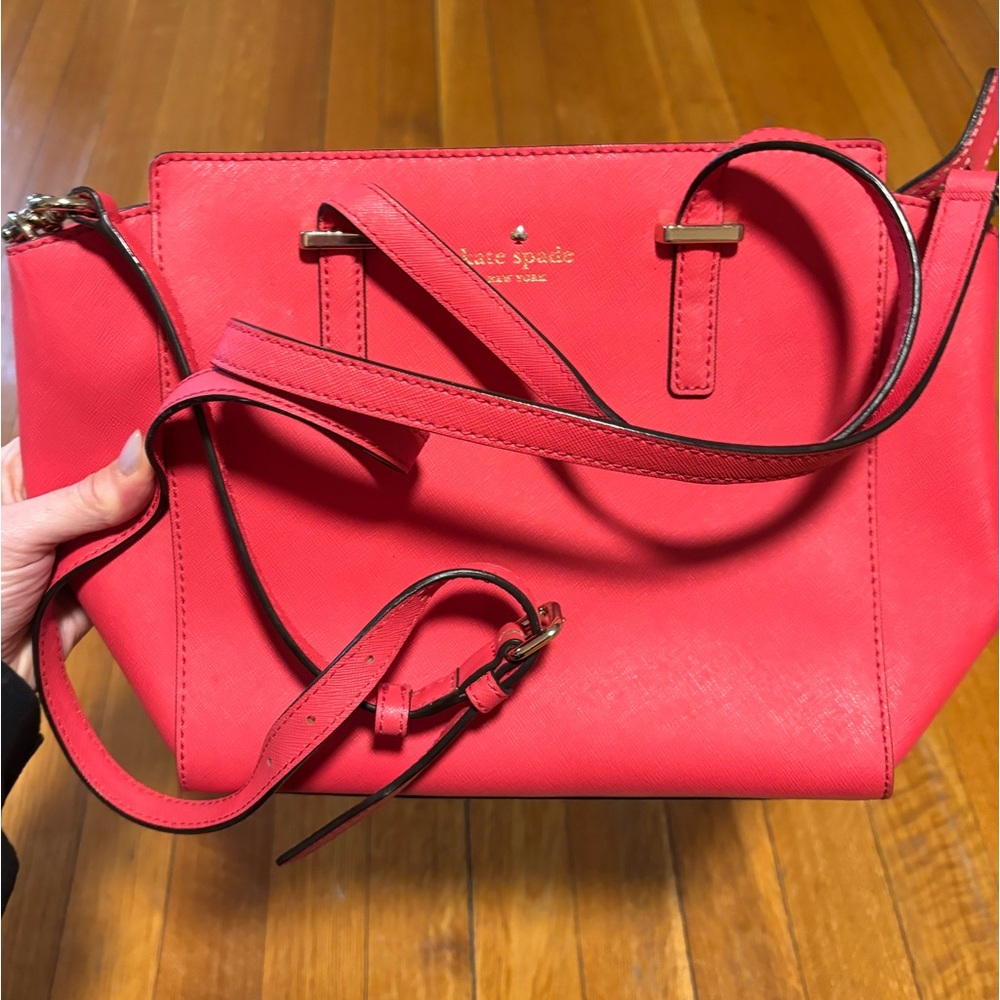 Kate Spade coral red handbag with shoulder strap.